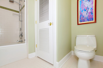 Fototapeta na wymiar Green bathroom with tub and cherry painting