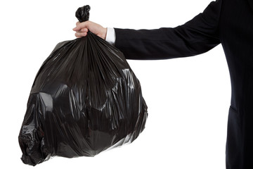 Business man's arm holding a bag of trash