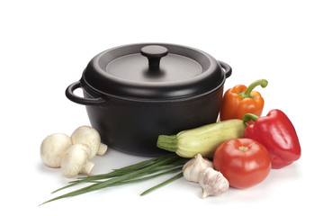 black cast-iron cauldron with vegetables