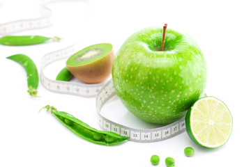 apple,lime,peas,kiwi and measure tape isolated on white