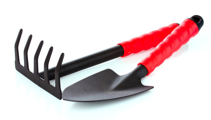 Gardening trowel  and rake on a white background
