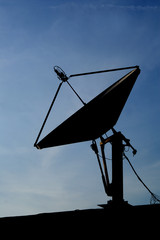 Satellite Dish Silhouetted On Dark Sky