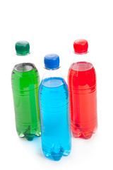 three colored plastic bottle with juice