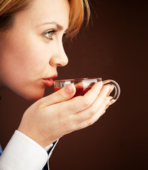 Five-o'clock tea. White collar woman relaxing with hot tea