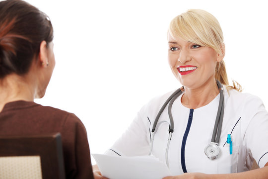Mature female doctor talking with patient.