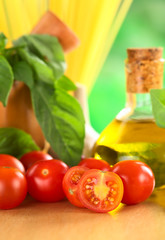 Cherry tomatoes on wooden board with other ingredients