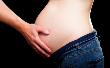 Pregnant woman on black background