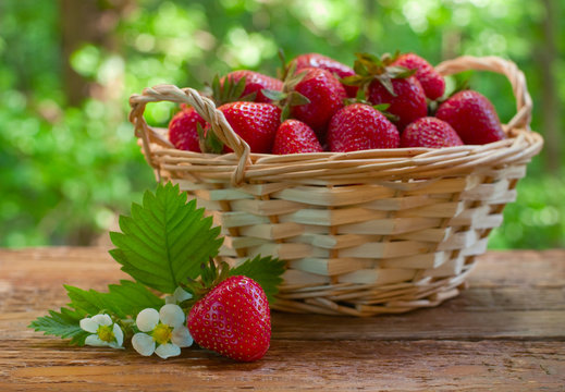 Strawberries in basket on garden table