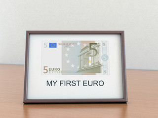 Five euro in the a frame with the inscription "My first euro"