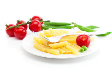tomatoes, peas, pasta and fork on a plate isolated on white