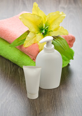 flower on towels with tube and bottle
