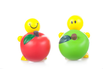 Smiling toy little men with the big apples.