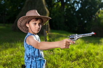 Fototapeta premium Cute kid playing cowboy