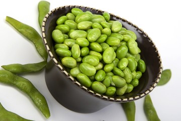 Edamame soy beans in a brown ceramic dish