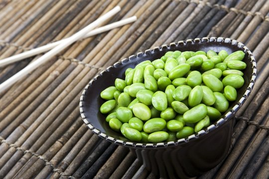 Edamame soy beans in a brown ceramic dish