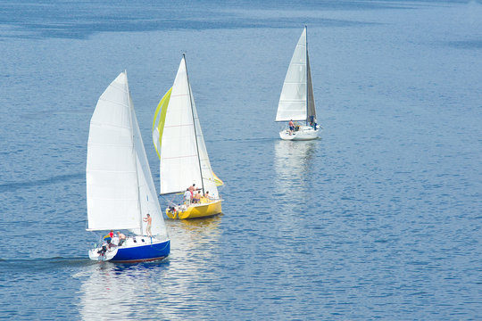 Sail away - three yachts on a summer river.