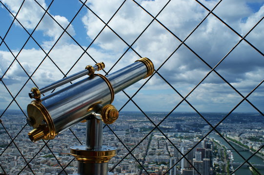 Paris, view of the Eiffel Tower with telescope in foreground.