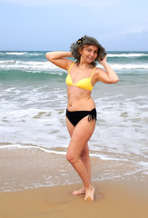 Fototapeta na wymiar slender woman on the beach