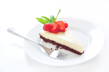Piece of cheesecake with strawberry on a plate