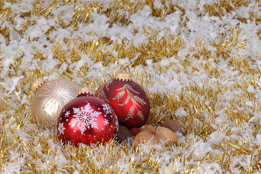 Christmas ornaments on background of garland and snok flakes