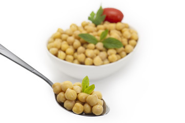 Close up view of chickpea in bowl on white background