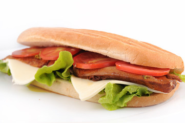 long whole wheat baguette sandwich with meat, veggies cheese