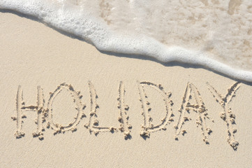 Hoilday Written in Sand on Beach