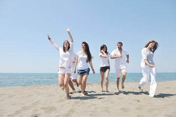 Group of happy young people in have fun at beach