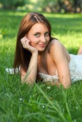Pretty young girl relaxing on the lawn