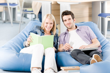 Fototapeta premium Happy smiling high-school students listen to music