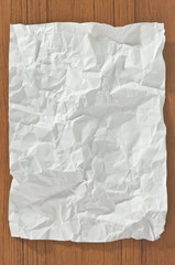 Crumpled blank paper on wooden table