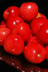 Sweet cherries isolated on black