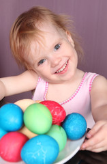 Fototapeta na wymiar The joyful girl and easter eggs