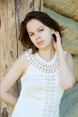 Young woman near wooden background