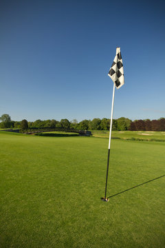 Flag on idyllic golf course