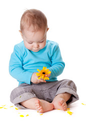 Small baby playing with yellow flower