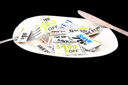 Grocery Coupons On A Plate With Fork And Knife Budgeting Concept