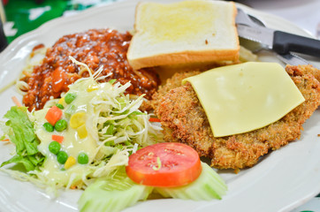 Fresh chicken steak with salad and spaghetti