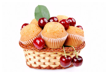 Basket with delicious muffins, cherries