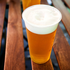 glass of beer standing on a wooden table