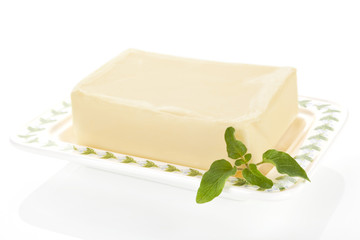Butter on butter tray isolated on white.