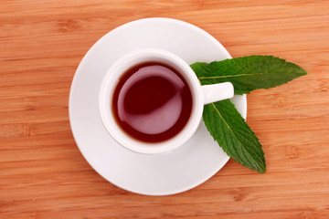 Cup  with mint on wooden table