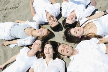 Fototapeta na wymiar Group of happy young people in have fun at beach