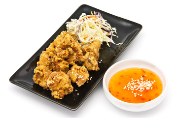 fried chicken in black plate with sauce