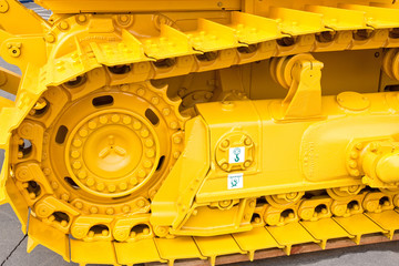 Yellow metall caterpillar band of construction digger