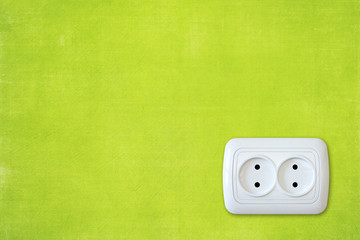 bright green wall with white electric outlet.