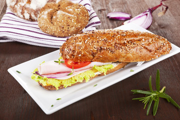 Wholegrain baguette on white tray.
