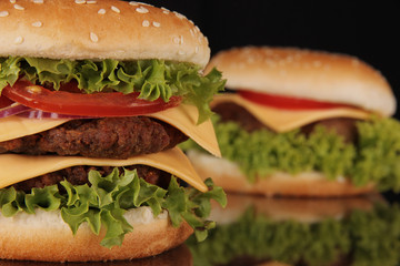 delicious hamburgers on black background