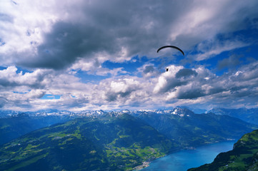 Dramatic clouds over Alps, Walensee lake, paraglider silhouette - 32928443