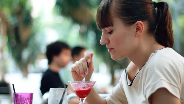 Woman eating fruit plate outdoor